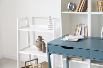 Blue desk near bookcase in room