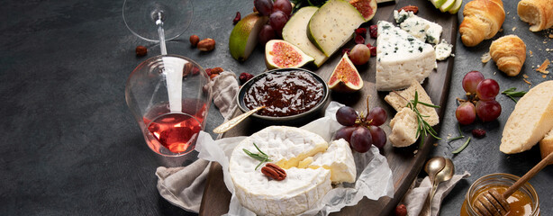 Cheese assortment on dark background.