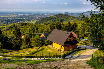 Panoramic view of northern slope of Little Beskids in Beskidy Mountains with wooden village house Targanice village near Andrychow in Lesser Poland