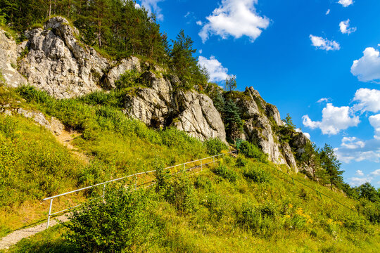 Zabi Kon and Mnich rock with path to Holy Mary cave shrine in Kobylanska Valley within Jura Krakowsko-Czestochowska upland near Cracow in Lesser Poland
