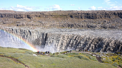 Iceland - August 3, 2021: Tourists at Dettifoss. The waterfall is situated in Vatnajökull National Park in Northeast Iceland, and is reputed to be the most powerful waterfall in Europe