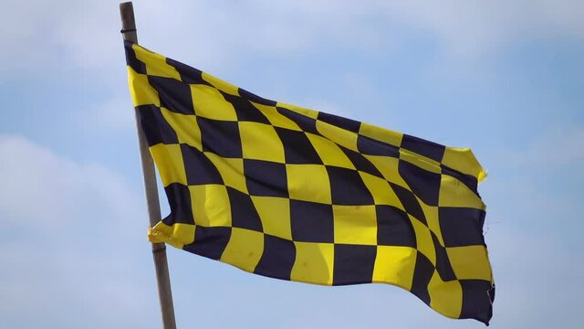 Yellow And Black Checkered Flag In Slow Motion 120fps