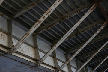 Close-up shot of old metal mesh bridge construction with signs of rust.