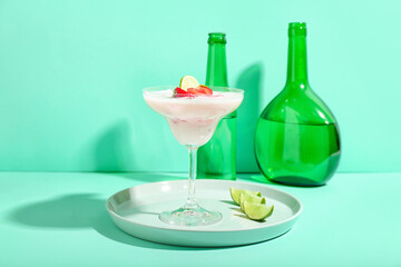 Glass of strawberry Pina Colada cocktail on color background