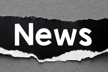 NEWS. Word news on black paper. Concept for business.