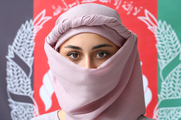 Muslim woman against flag of Afghanistan