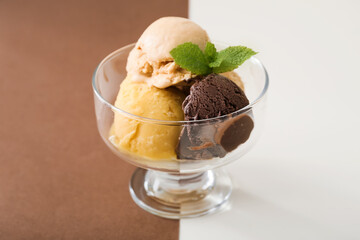 Bowl of delicious different ice cream balls on color background