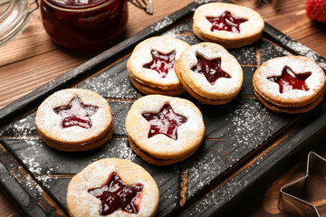 Board with tasty Linzer cookies on table