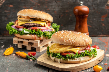 Craft beef burgers with vegetables on rustic wooden background. fast food and junk food concept