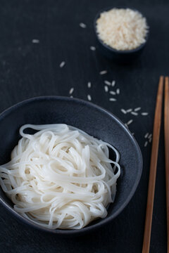rice nudles on dark stone surface