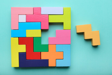 Multicolored puzzle, cubes on a blue background top view