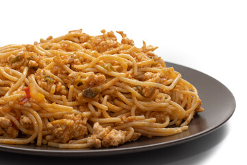 Plate covered with delicious Italian spaghetti, with tomato sauce. Isolated on white background. Healthy life concept.