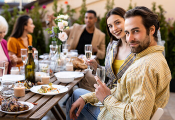 Family and friends celebrating at dinner on a rooftop terrace