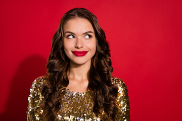 Photo of dreamy young thoughtful woman look empty space smile christmas party isolated on red color background