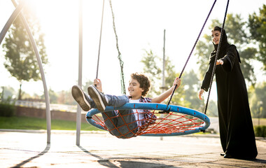 Woman with her children at the playground