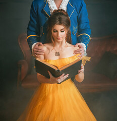 Woman princess holding a book without title cover design reads the text. Fantasy man enchanted...