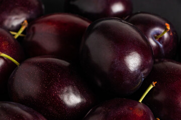 plums on a black background