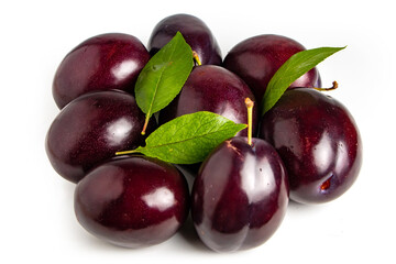 Plums with plum leaves on a white background.