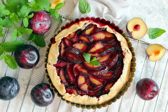 Tasty galetta with plums. Top view with copy space. Healthy food.