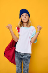 Fototapeta na wymiar stylish girl with a red school backpack gesturing with her hands