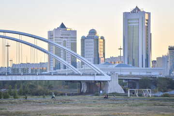 Naklejka premium astana city, nur sultan city, building, skyline, architecture, skyscraper, river, bridge, urban, water, business, sky, cityscape, tower, buildings, office, kazakhstan, downtown, travel, park, florida,