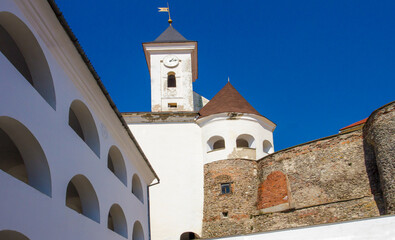 Fototapeta na wymiar white clock tower of an ancient castle