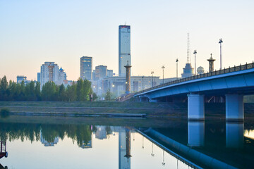 Fototapeta premium astana city, nur sultan city, building, skyline, architecture, skyscraper, river, bridge, urban, water, business, sky, cityscape, tower, buildings, office, kazakhstan, downtown, travel, park, florida,