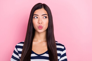 Photo of flirty long hairdo young millennial lady blow kiss empty space wear striped t-shirt isolated on pastel pink color background