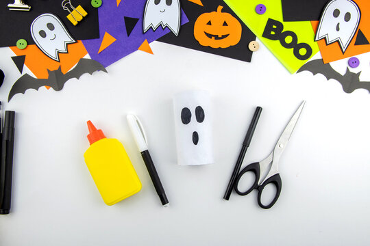 Craft with a child for Halloween from rolls of toilet paper and colored ghost paper. Step-by-step instruction. Step 2.
