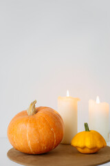 large orange pumpkins on a white background with a candle. Autumn mood