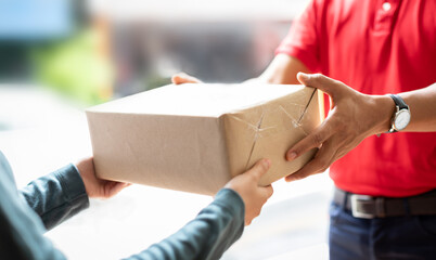 Hands of woman receiving parcel. Delivery man service sending boxes product at the door. Express...
