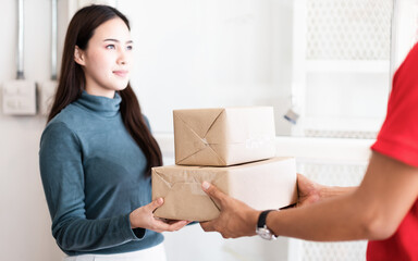 Woman receiving parcel from delivery man at the door, Postman delivery packet product at home, Stay...