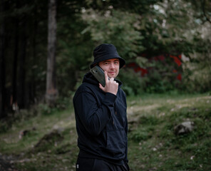 Fototapeta premium Man talking on the phone and looking at the camera