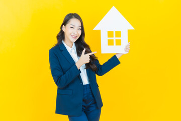 Portrait beautiful young asian woman with house or home paper sign