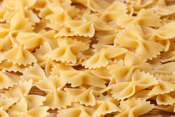 Authentic pasta background in the form of bows. Close-up. Selective focus