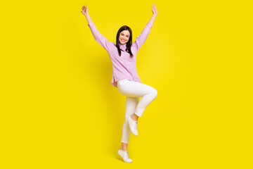 Fototapeta na wymiar Full length body size view of attractive cheerful girl rejoicing having fun isolated over bright yellow color background