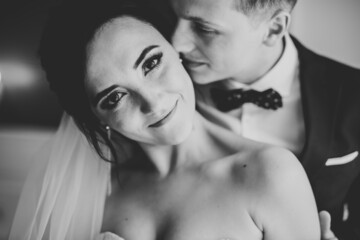 Romantic wedding moment, couple of newlyweds smiling portrait, bride and groom hugging