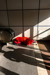 Woman sleeping in subway entrance