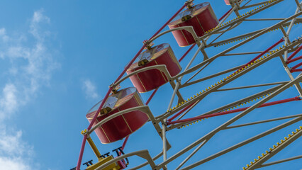 Ferris Wheel With Cabins.carousel against blue sky in a amusement park.