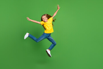 Fototapeta na wymiar Full length body size view of attractive cheerful girl jumping having fun isolated over vivid green color background