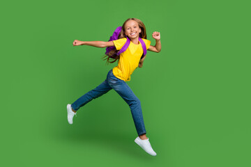 Full length body size view of lovely cheerful girl jumping running to college isolated over vivid green color background