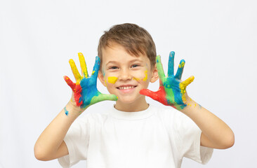 Happy kid with paints on hands