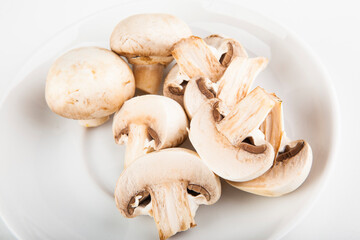 chopped champignons on a white plate to add to pizza