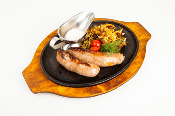 bavarian sausages with stewed cabbage and sauce in a pan