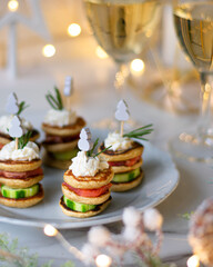 Christmas tree canape with cucumber slice, salmon pate and red caviar for festive xmas snack. Vertical