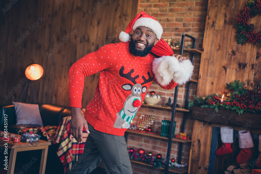 Canvas Prints Photo of cute adorable dark skin man wear red sweater holding santa claus sack walking smiling indoors room home house