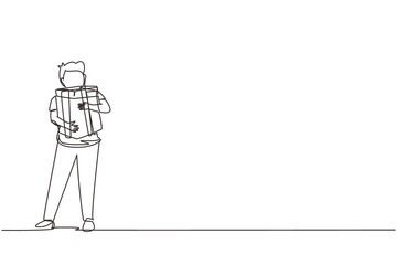 Continuous one line drawing kid standing and hugging ribbon bow wrapped gift box in front of his in arms. Cute little boy carries holiday gift box with bow in his hands. Single line draw design vector