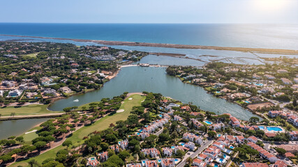 Aerial overview of luxury villas located around Quinta do Lago, Algarve, Portugal, Europe. Drone...
