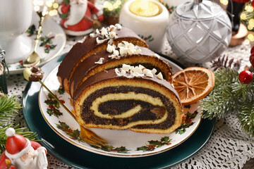 Christmas poppy seed roll cake on festive table