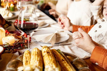 Close-up holiday decorated table for Thanksgiving day with wine and traditional food, dishes.